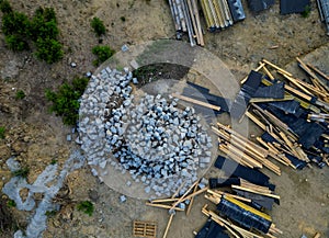 drone view of construction site. strewn boards and stone tiles in a pile.