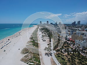 Drone view of the crowded South Beach with beautiful modern buildings along the shore in Miami