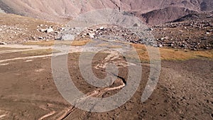 Drone view of a dried-up riverbed in the mountains