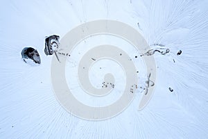 Drone view of eco adventure tourists in an ice crater and glacial field