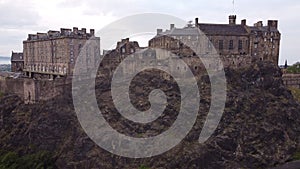 Drone view of Edinburgh Castle with impregnable walls on a stone cliff.