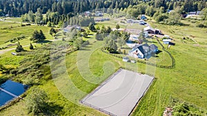 Drone view of farm house and green pastures