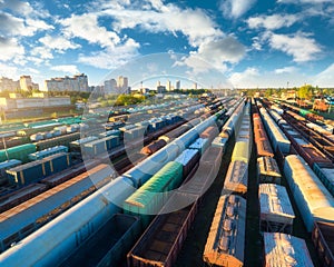 Drone view of freight trains at sunset. Railway cargo wagons