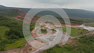 Drone view of geothermic geysyr valley in Iceland. Steaming geothermic active icelandic field of geyser. Tourism