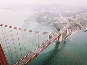 Drone view of the Golden Gate Bridge covered in the fog in San Francisco, California