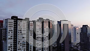 Drone view of high skyscrapers and residential buildings in Mexico City at sunset