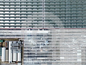 Drone view of a huge commercial glass house growing commercial plants.