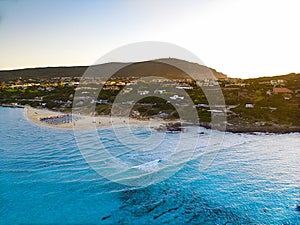 Drone view of Isola Piana by La Pelosa Beach, Sardinia. Well-preserved ruins of Torre di Punta Imbarcatogio, a defensive and