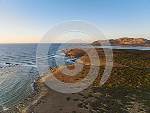 Drone view of Isola Piana by La Pelosa Beach, Sardinia. Well-preserved ruins of Torre di Punta Imbarcatogio, a defensive and