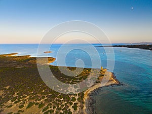 Drone view of Isola Piana by La Pelosa Beach, Sardinia. Well-preserved ruins of Torre di Punta Imbarcatogio, a defensive and