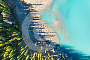 Drone view of the lake and forest in the glacier valley. View of the moraines. Landscape from the air.  River on a moraine. Landsc