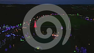 Drone View of a Large Christmas Display, Over Many Acres of Trees, A Pond, Gazebo, Shrubs at Dusk