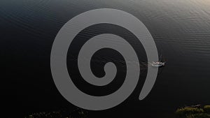 Drone view of luxury boat cruising in high speed in blue sea