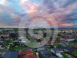 Drone view of Melbournes suburbs and CBD looking down at Houses roads and Parks Victoria Australia. Beautiful colours at Sunset