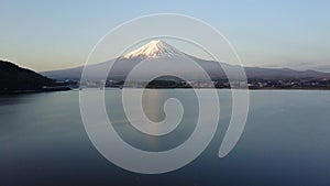 Drone view of Mountain Fuji reflected in Kawaguchiko lake on a sunny day and clear sky