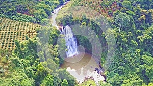 Drone view mountain river turns out to waterfall among rainforest