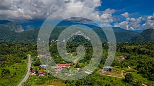 Drone view of Mulu village surrounded by tropical forest and mountains near Gunung Mulu national park. Borneo. Sarawak.