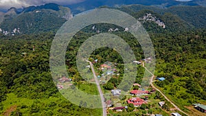 Drone view of Mulu village with tropical forest and mountains near Gunung Mulu national park. Borneo. Sarawak.