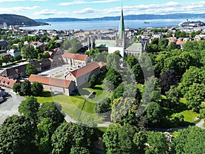 Drone view of the Nidaros Cathedral surrounded by greenery in Trondheim, Norway
