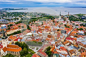 Drone view of the Old Town Tallinn surrounded by the sea under a cloudy sky in Estonia