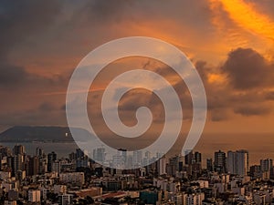 Drone view over the cityscape of Miraflores District with the Pacific Ocean in background at sunset in Lima, Peru
