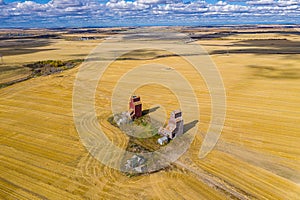 Drone view over the Lepine Grain Elevators in the yellow field under the sunlight