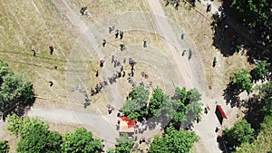 Drone view of park with start area of bike race and cyclists waiting for competition