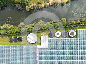 Drone view of a part of a huge commercial glass house growing young plants.