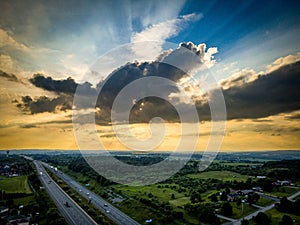 Drone view of the Port Hope streets surrounded by buildings and nature during a colorful sunset photo