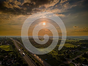 Drone view of the Port Hope streets surrounded by buildings and nature during a colorful sunset photo