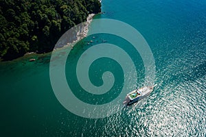 Drone view of a sailing yacht in the turquoise sea