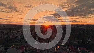 Drone View of a Small Town and a Steeple at Sunrise as it gets Ready to Break the Horizon