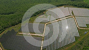 Drone view of a solar power station next to a forest during summer. Renewable energy meets nature in action