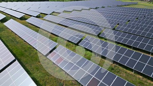 Drone view of a solar power station next to a forest during summer. Renewable energy meets nature in action