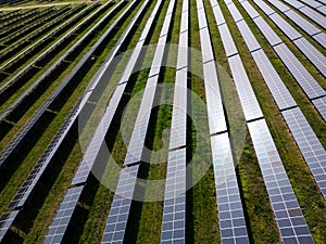 drone view of a solar power station next to a forest during summer. Renewable energy meets nature in action