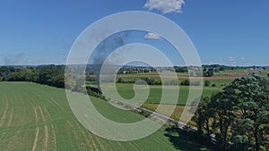 Drone View of a Steam Engine Rounding a Curve Thru Farmlands in Slow Motion