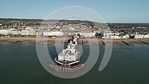 Drone view of the stunning Eastbourne Pier with a church in England, United Kingdom