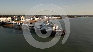 Drone view of the stunning Eastbourne Pier with a church in England, United Kingdom