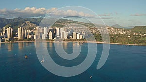 A drone view at sunset of Waikiki Beach and Diamond Head Crater, a famous tourist destination in Honolulu, Oahu, Hawaii