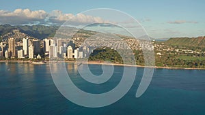 A drone view at sunset of Waikiki Beach and Diamond Head Crater, a famous tourist destination in Honolulu, Oahu, Hawaii