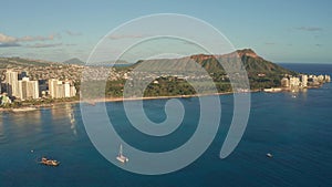 A drone view at sunset of Waikiki Beach and Diamond Head Crater, a famous tourist destination in Honolulu, Oahu, Hawaii