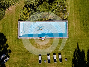 Drone view at swimming pool above with man and woman swimming Stellenbosch, near Cape Town, South Africa