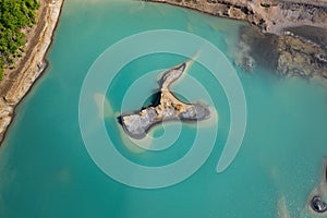 Drone view of the turquoise lake formed as a result of mining waste photo