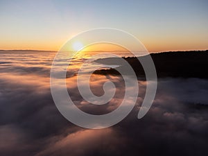 Drone view of Umbria valley Italy above a sea of fog at sunset