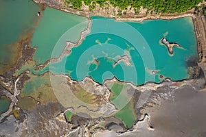 Drone view of the turquoise lake formed as a result of mining waste