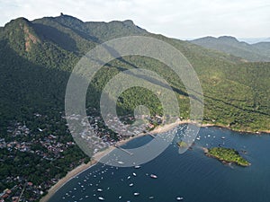 Drone view of Vila do Abraao surrounded by the sea in Brazil photo