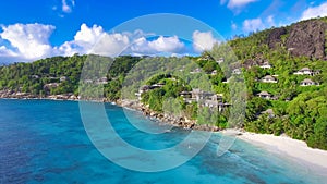Drone viewpoint of beautiful Anse La Liberte\', Seychelles coastline on a sunny day