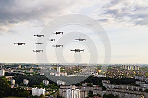 Drones flying over the houses of the city of Minsk. Urban landscape with drones flying over it.Quadrocopters fly over the city