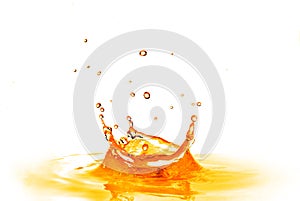 Drop falling into orange water with splash isolated on white