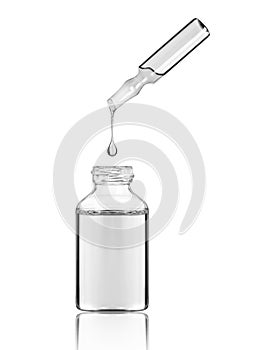 Drop falls from a cosmetic or medical ampoule into a bottle